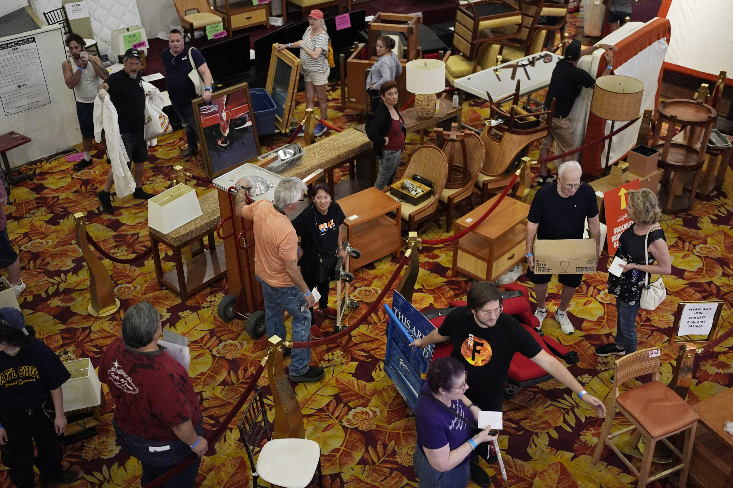 People line up to pay for items during a sale at the shuttered Tropicana hotel-casino Saturday, May...