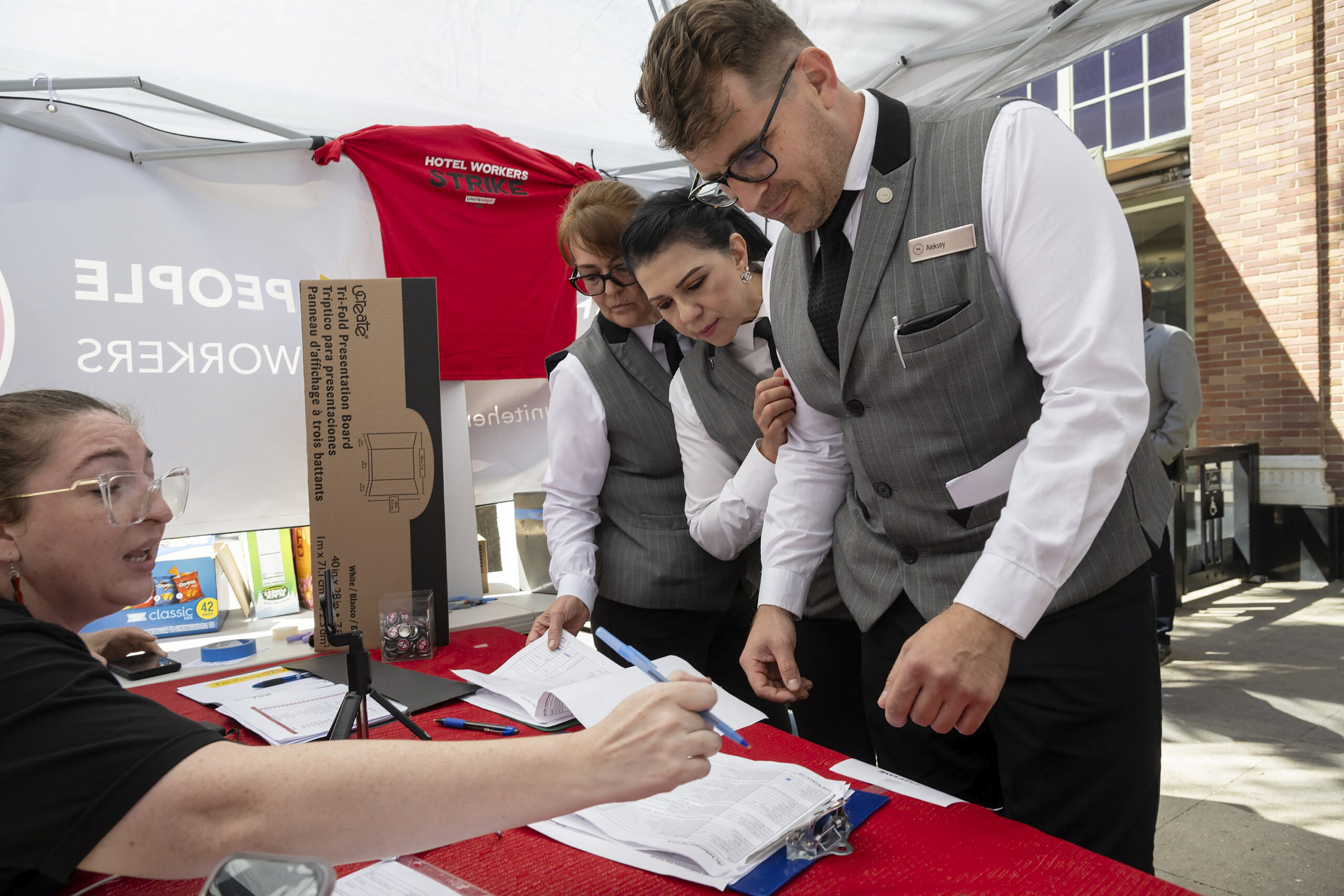 Sheraton Grand Hotel workers Lupe Ventura, center, and Alex Ivanitsky, right, who are represented b...