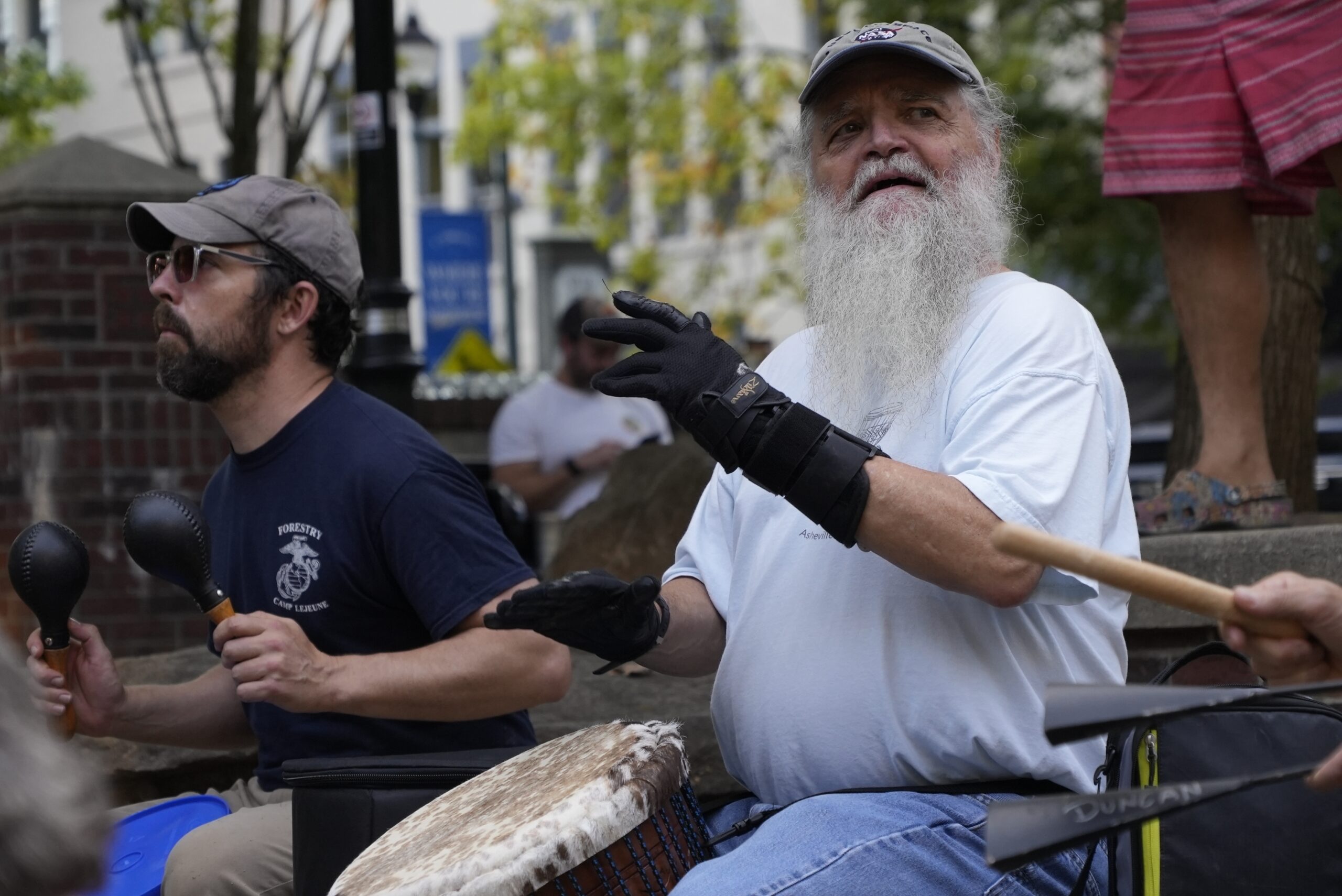 Mel McDonald plays music at a drum circle Friday, Oct. 4, 2024 in Asheville, N.C., a week after Hur...