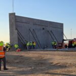 Workers put up a wall during construction at Verrado Marketplace in Buckeye.