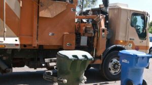 Woman rescued after getting stuck inside garbage truck in Phoenix