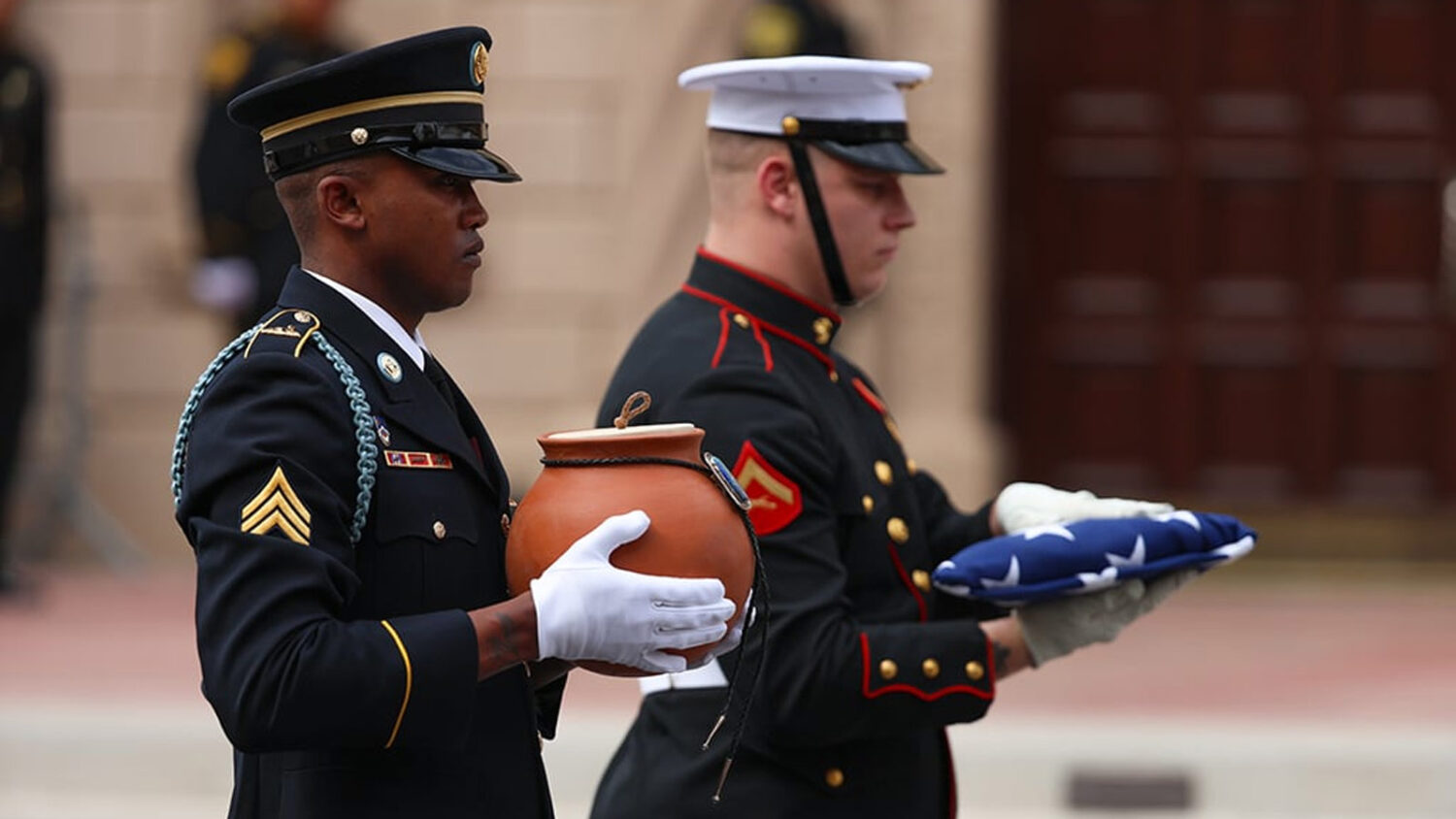 The Honor Guard carries the cremated remains of Congressman Raúl Grijalva into St. Augustine Cathe...