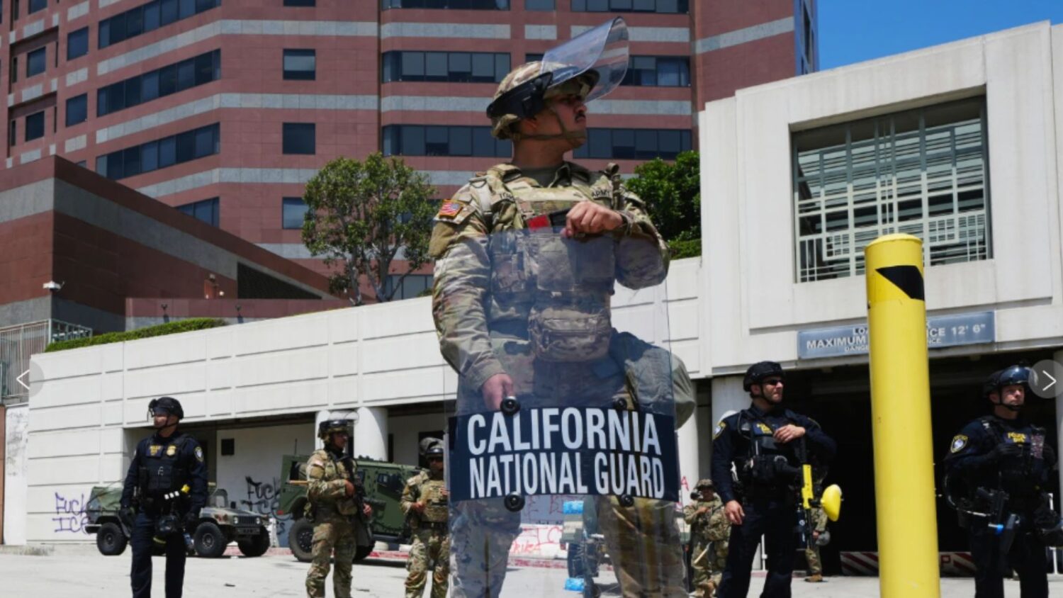 U.S. National Guard stand protect buildings Tuesday, June 10, 2025, in Los Angeles. (AP Photo Damia...