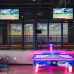 Batting cages and an air hockey table at the new Taroko Sports location in Mesa are pictured. (Michael Anthony)