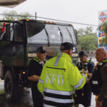 Members the Kerrville Fire Department and Texas Department of Public Safety refuel trucks after deadly flooding in Kerrville, Texas, Friday July 4, 2025. (Christopher Lee/The San Antonio Express-News via AP)