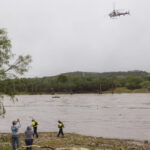 A Texas DPS helicopter conducts arial searches along the Guadalupe River in the wake of a destructive flooding event in Kerrville on Friday July 4, 2025. (Christopher Lee/The San Antonio Express-News via AP)