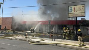Firefighter hit in head while dousing flames at building in Phoenix