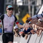 A runner high-fives fans during an Ironman Arizona triathlon. (Ironman photo)