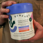 Stephen Dexter holds a container of ByHeart baby formula. (AP Photo/Cheyanne Mumphrey)