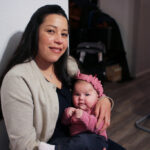 Yurany Dexter holds her 4-month-old daughter, who was recently hospitalized for botulism. (AP Photo/Cheyanne Mumphrey)