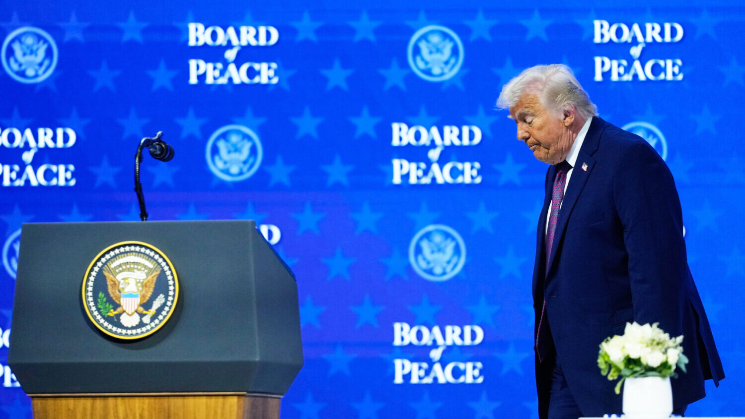 President Donald Trump walks on the podium after a signing ceremony of his Board of Peace initiativ...