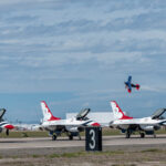 Ed Hamil, pilot of the Folds of Honor biplane, demonstrates aerial acrobatics in front of the U.S. Air Force Demonstration team, the "Thunderbirds," during Luke Days 2024, March. 23, 2024, at Luke Air Force Base, Arizona. Families and aviation enthusiasts alike gathered at Luke Days 2024 to marvel at thrilling performances. (U.S. Air Force photo by Senior Airman Jakob Hambright)