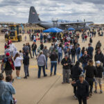 Luke Days 2024 attendees walk around a C-130 Hercules during Luke Days 2024, March 24, 2024, at Luke Air Force Base, Arizona. The C-130 was one of numerous aircraft on display at Luke Air Force Base during the two-day airshow. (U.S. Air Force photo by Staff Sgt. Noah D. Coger)