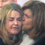 Savannah Guthrie, left, gets a kiss form Hoda Kotb during a visit to the Today show at Rockefeller Plaza on Thursday, March 5, 2026, in New York. (Photo by Charles Sykes/Invision/AP)