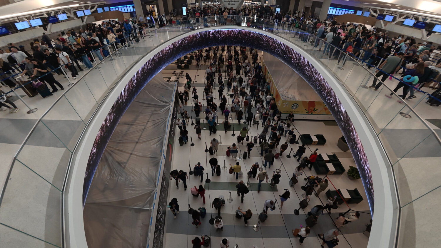 Travelers line up at a TSA checkpoint at George Bush Intercontinental Airport in Houston, Thursday,...