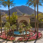 A tranquil koi pond winds through the landscape, adding a sense of calm and natural beauty to the already impressive outdoor environment.