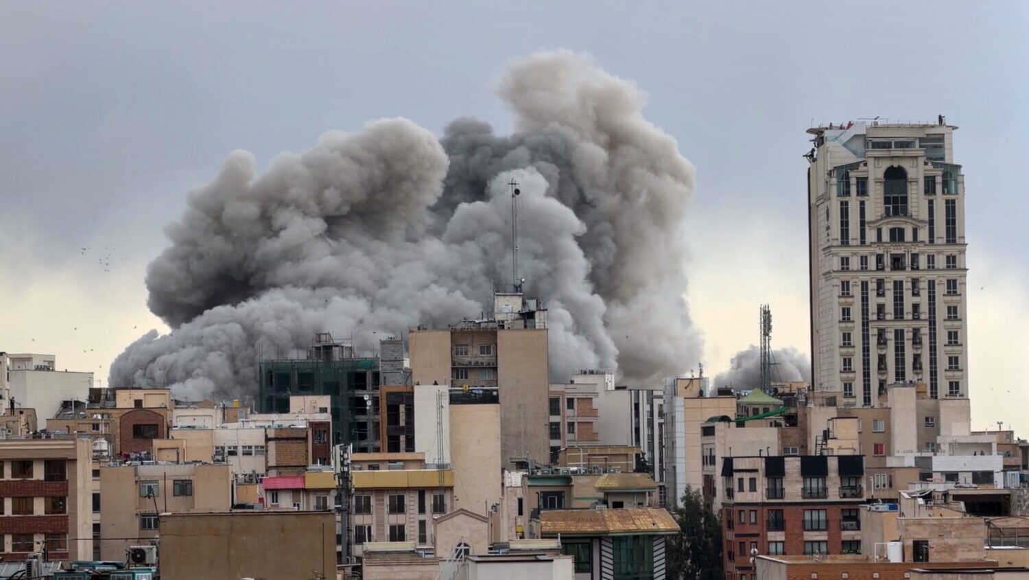 A plume of smoke rises after a strike in Tehran, Iran, Monday, March 2, 2026. (AP Photo/Mohsen Ganj...