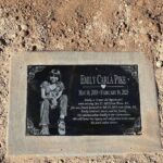 Permanent plaque with photo of Emily Pike placed at Mesa park where she played