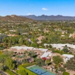 Tall hedges and a surrounding block wall ensure complete privacy, transforming the estate into a secluded sanctuary hidden within one of the area’s most prestigious neighborhoods.