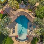 The home’s single level layout extends outward into generous patios and open air spaces that invite seamless indoor outdoor living.