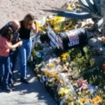 This image made from video provided by FOX News Digital shows Savannah Guthrie, right, her sister Annie Guthrie, left, and her brother-in-law Tommaso Cioni, Monday, March 2, 2026, visiting a tribute to their mother Nancy Guthrie. (FOX News Digital via AP)