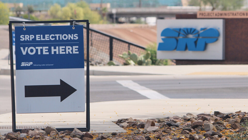 A sign directing voters sits outside the headquarters of Salt River Project on Monday, March 30, 20...