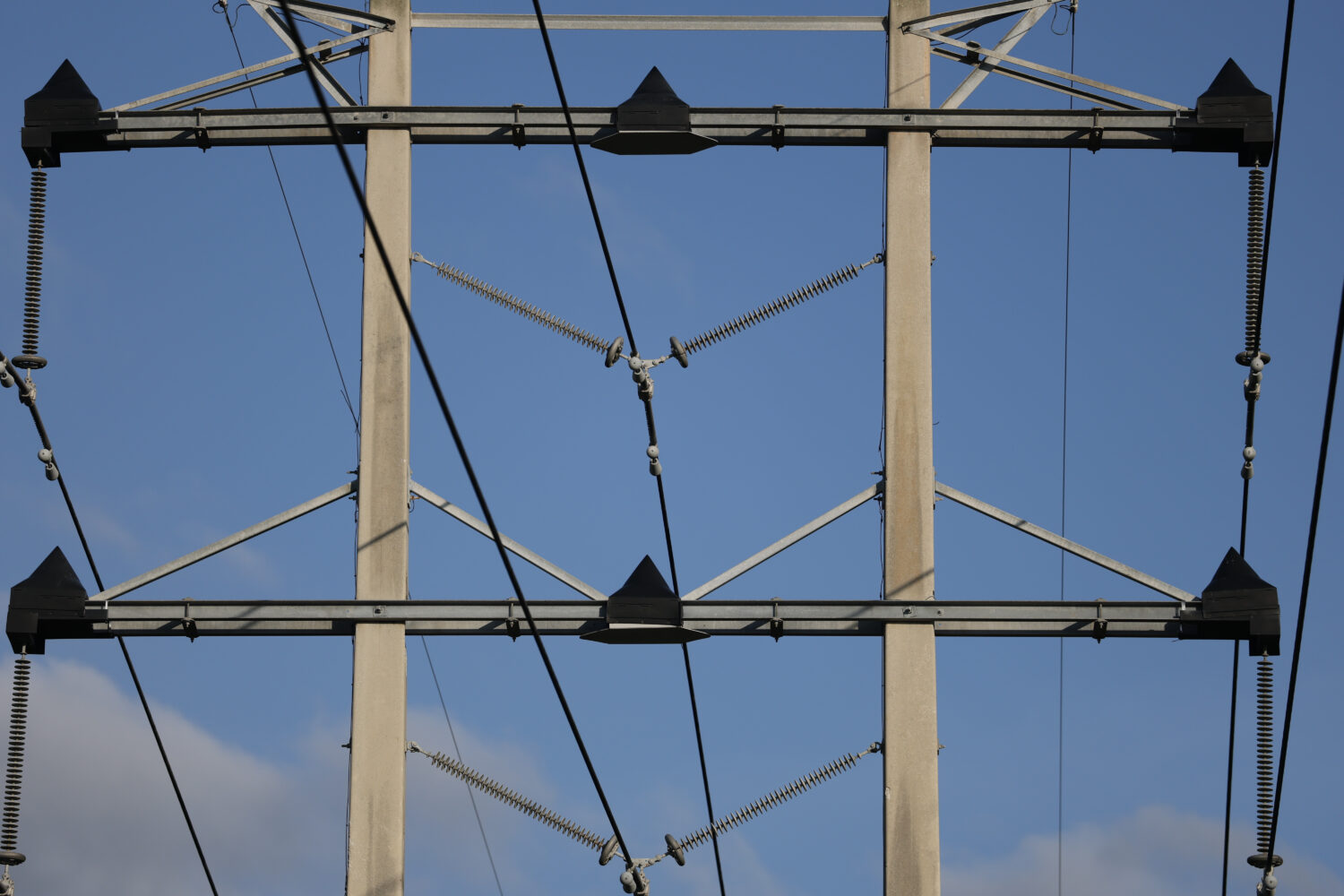 High voltage power lines run along the electrical power grid on January 14, 2026. Arizona data cent...