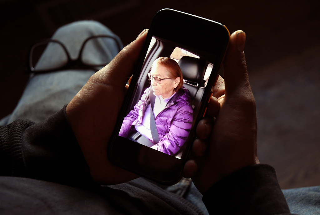 Gerald Begay, whose mother Ella Mae Begay went missing from her home, shows a photo of her on his p...