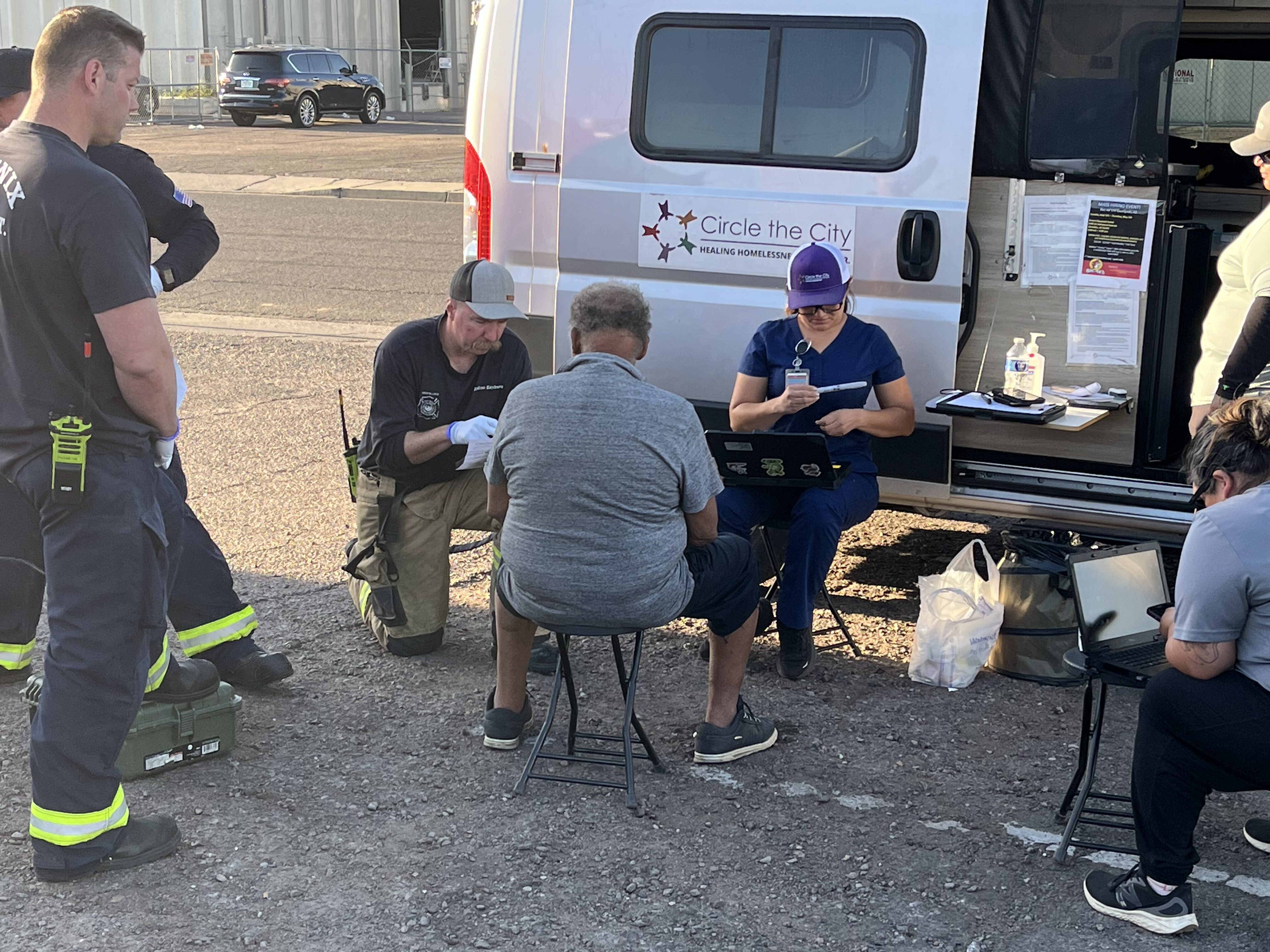 Food and medicine distribution were provided by volunteers with Circle the City at a local park on ...