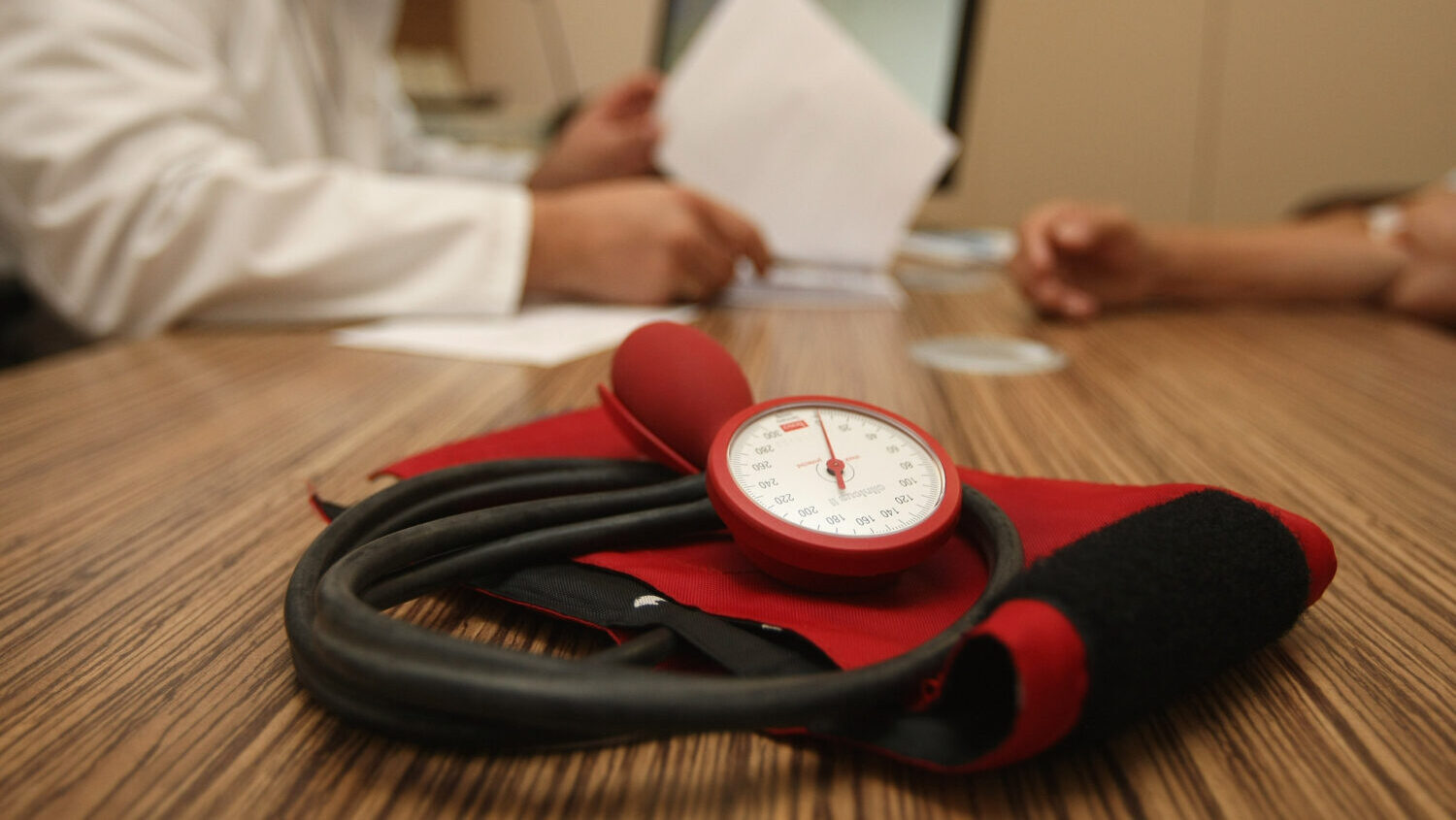 A blood pressure cuff sits on a desk as a doctor consults with a patient. Arizona's attorney genera...