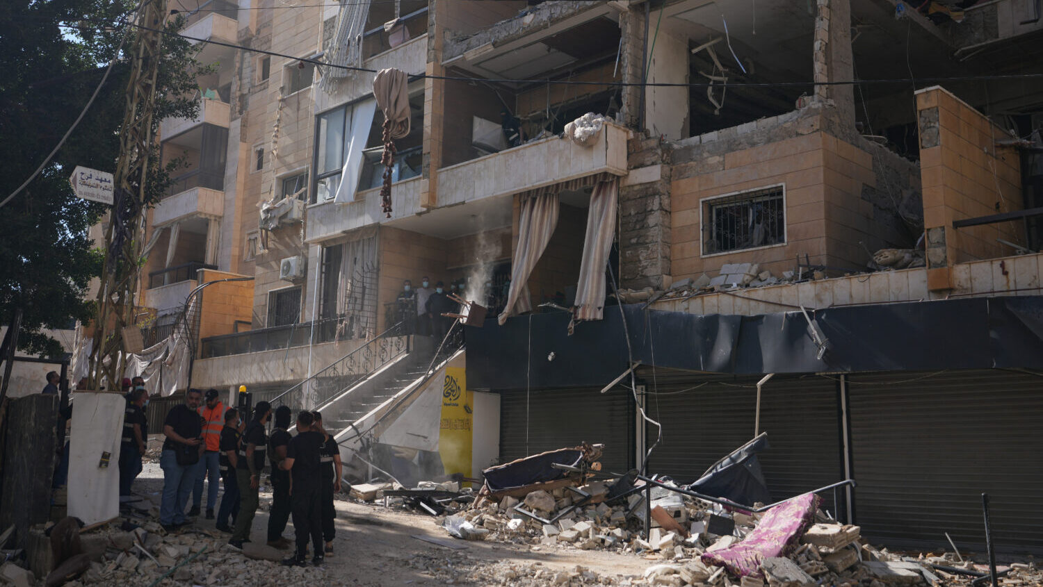 Lebanese security officers gather at the site where an Israeli airstrike hit a building in Dahiyeh,...