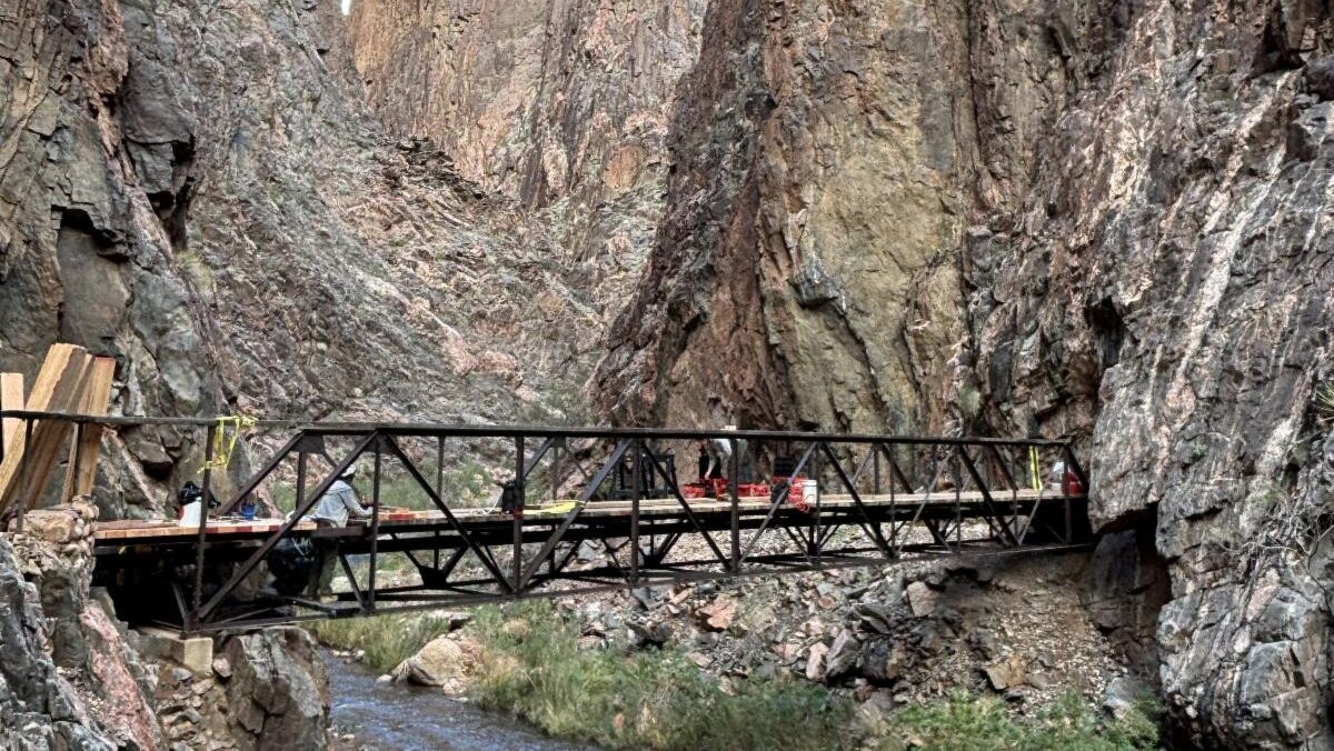 Crews work on a footbridge along the Grand Canyon's North Kaibab Trail. (National Park Service)...