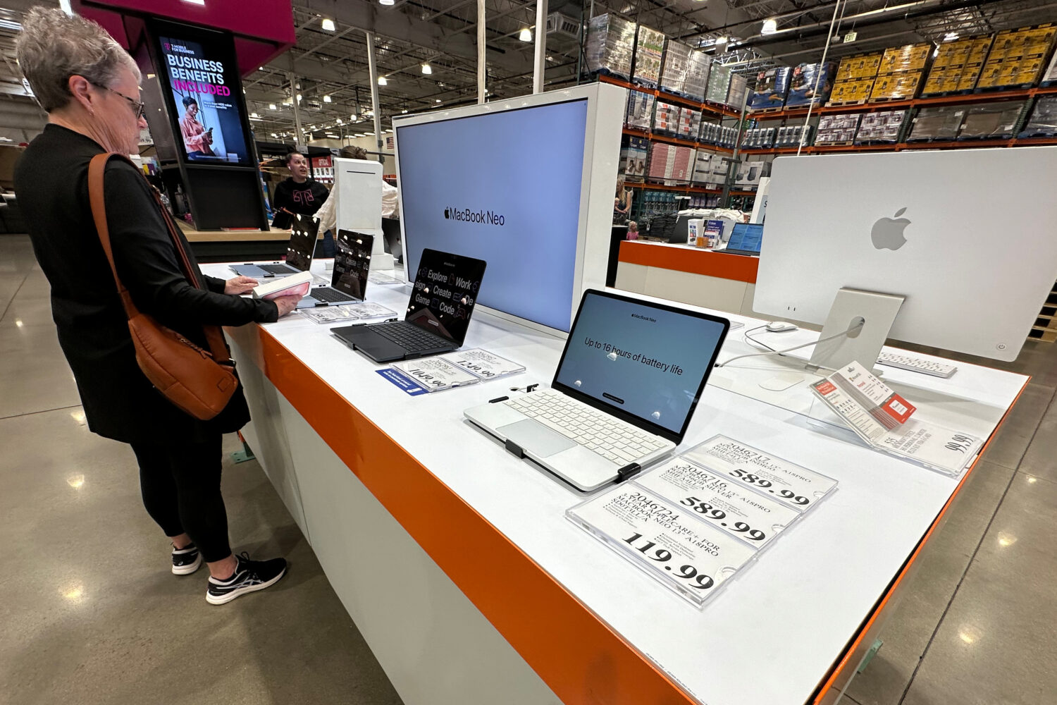 FILE - A shopper looks over Apple MacBook laptops on display in a Costco warehouse on June 2, 2026,...
