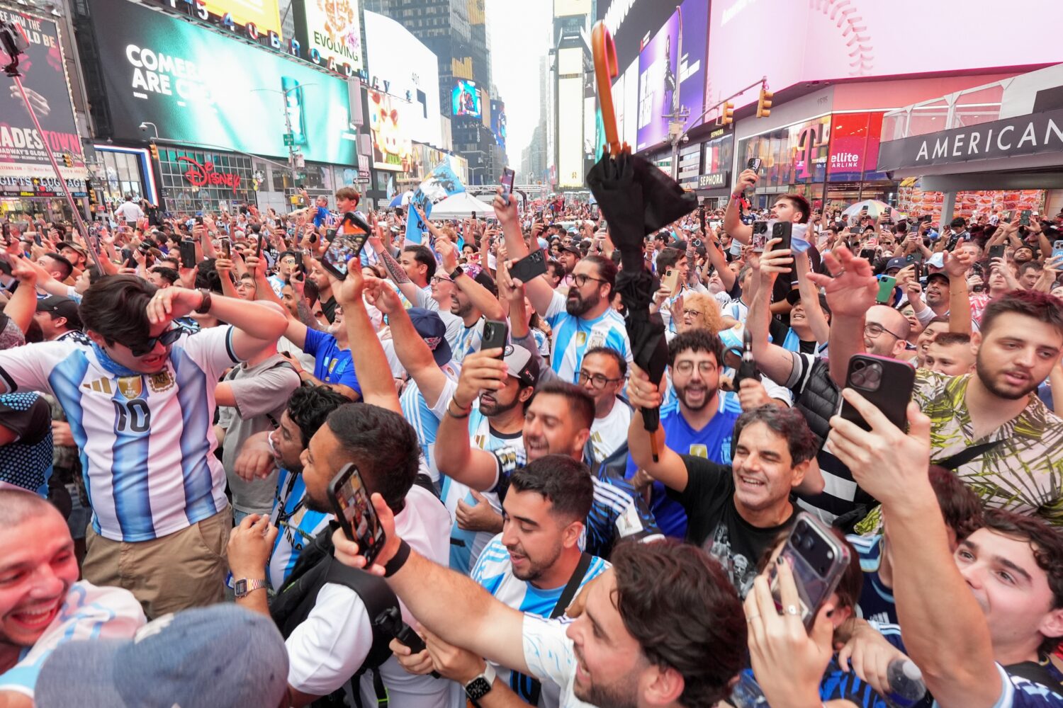 Argentina fans gather for a rally on the eve of the World Cup final soccer match in New York's Time...