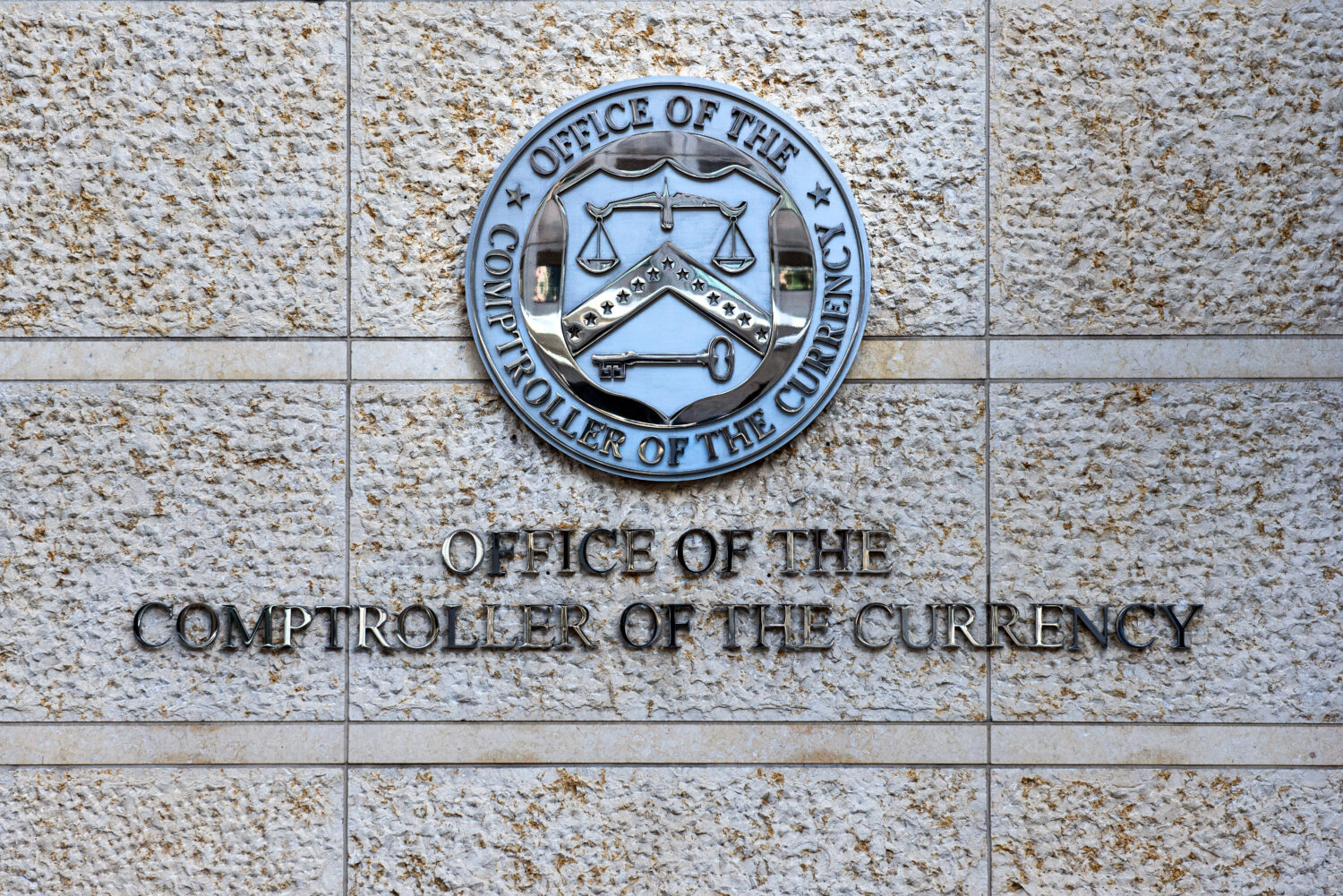 FILE - The official seal of the Office of the Comptroller of the Currency is seen on an office buil...