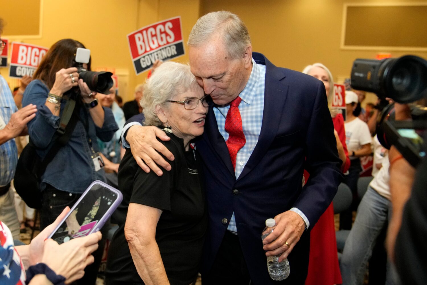 Rep. Andy Biggs, right, R-Ariz., who is running in the primary for Arizona governor, hugs a support...