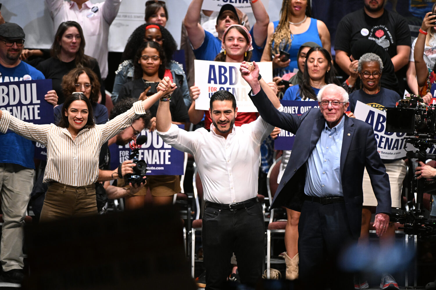 From left foreground, U.S. Rep. Alexandria Ocasio-Cortez, D-N.Y., Michigan Democratic U.S. Senate p...
