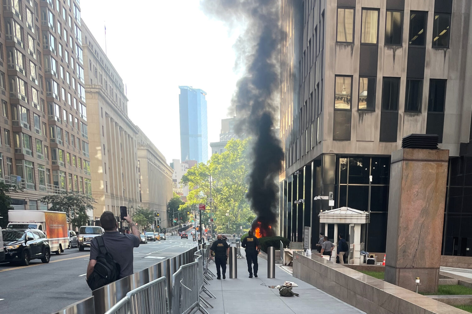 This photo provided by Robert Sullivan shows black smoke and flames in front of 26 Federal Plaza in...