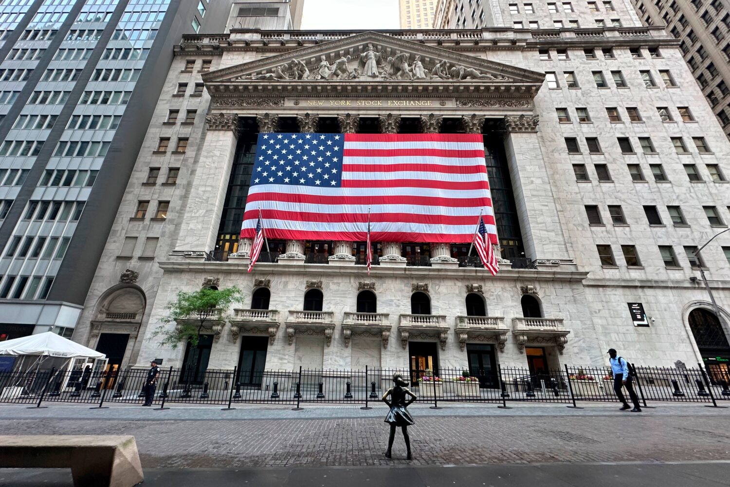 FILE - People pass the New York Stock Exchange on May 28, 2024, in New York. (AP Photo/Peter Morgan...