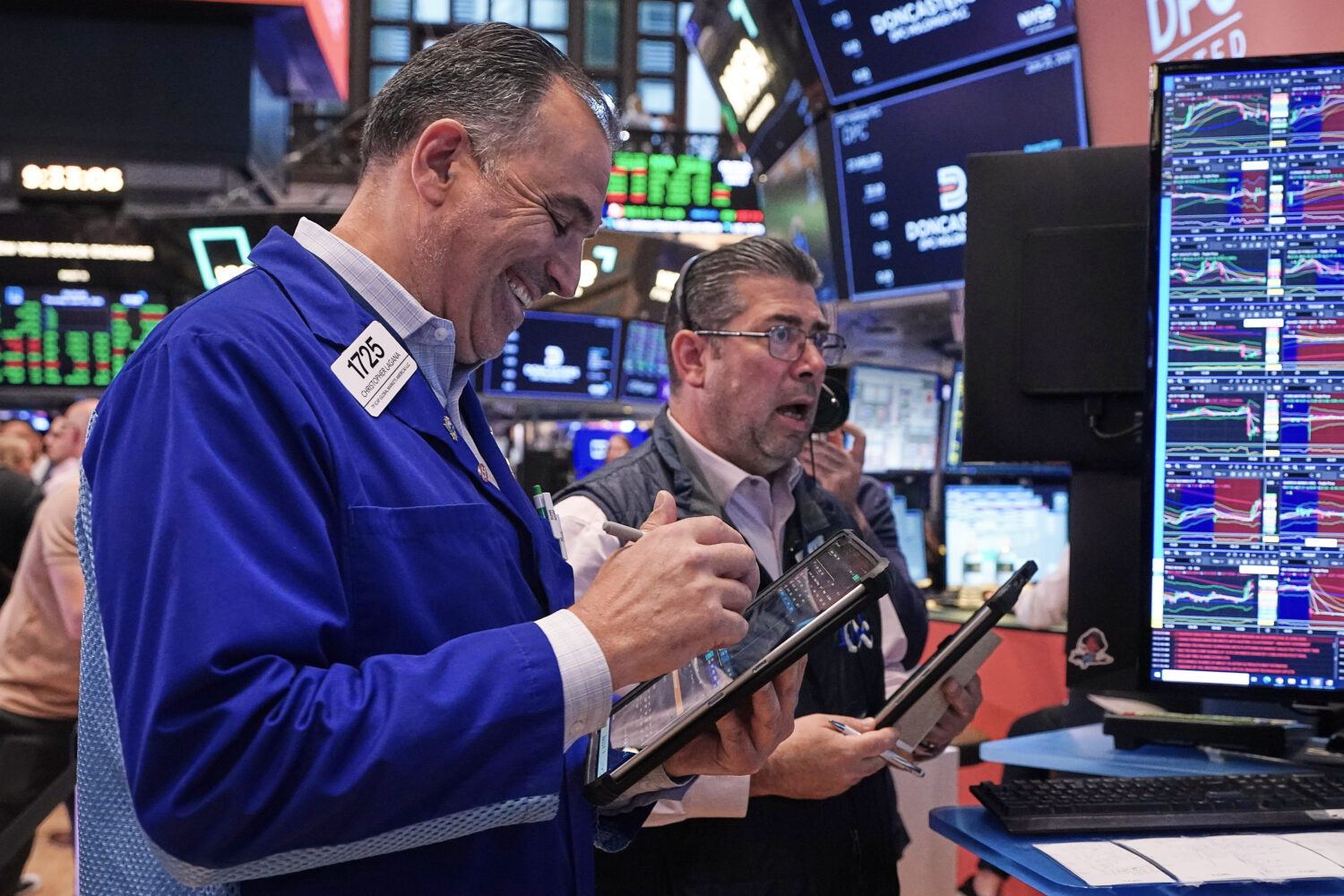 Traders Chris Lagana, left, and Michael Capolino work on the floor of the New York Stock Exchange, ...