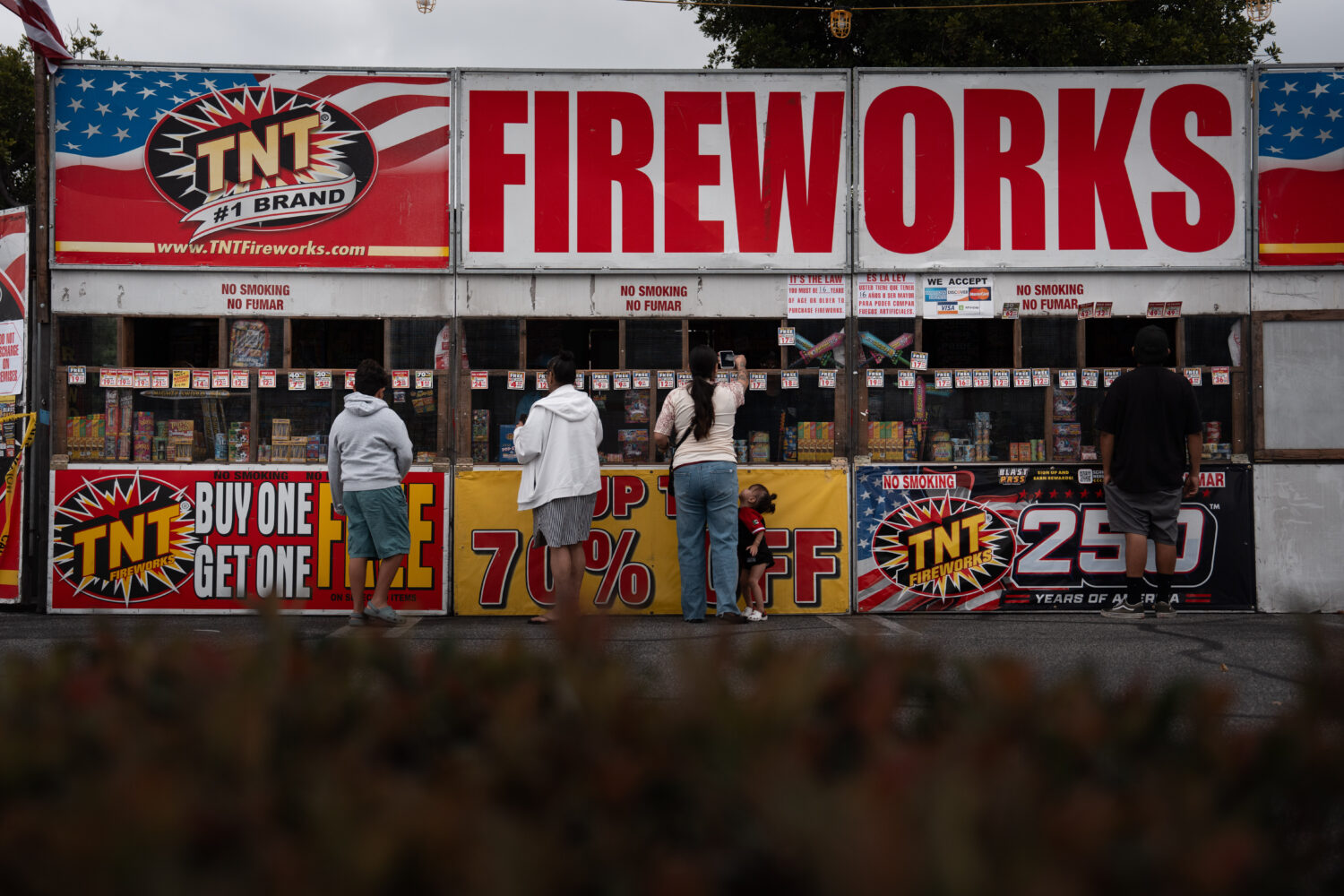 People purchase fireworks at a TNT Fireworks stand in Alhambra, Calif., Tuesday, June 30, 2026, ahe...