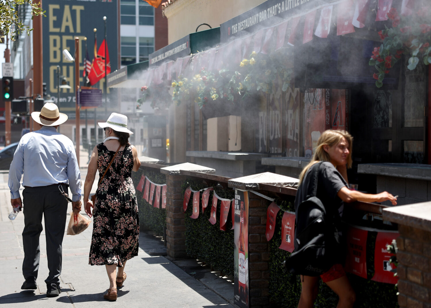 FILE -- Misters blow water amid extreme heat on July 25, 2023, in Phoenix. The National Weather Ser...
