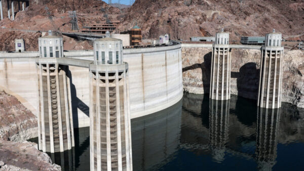 LAKE MEAD NATIONAL RECREATION AREA, ARIZONA - JULY 25: The two Arizona Intake Towers (L) and two Nevada Intake Towers on the upstream side of the Hoover Dam are shown on July 25, 2026 in the Lake Mead National Recreation Area, Arizona. This month, the combined water level of Lake Mead and Lake Powell, the country's two biggest reservoirs, fell to their lowest level since 1957, when the Glen Canyon Dam was being built and before Lake Powell was filled. The unprecedented low in combined storage could mean water and power shortages for the seven U.S. states and Mexico that depend on the Colorado River Basin, which supplies water to more than 35 million people, irrigates about 5 million acres of farmland, and generates hydropower from federal dams. The worsening water crisis could also influence ongoing negotiations between the seven states on water rights and usage. (Photo by Ethan Miller/Getty Images)