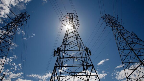 In this Aug. 30, 2007, file photo, the sun shines over towers carrying electrical lines during extreme heat in South San Francisco. (Justin Sullivan/Getty Images)