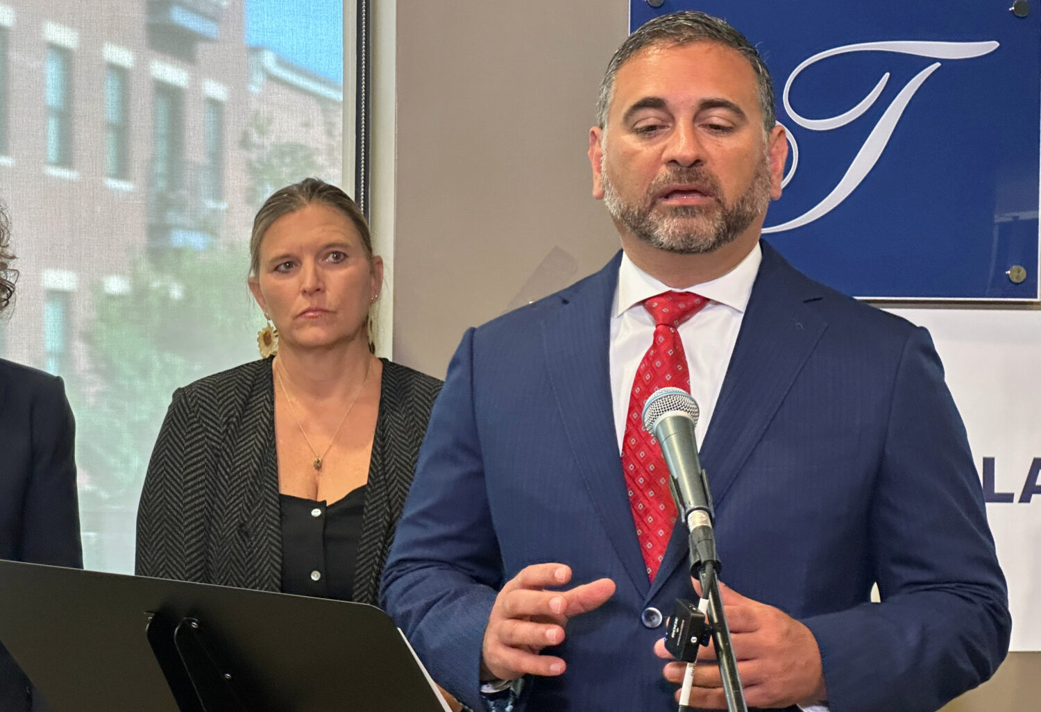 Tad Thomas, a lawyer for the family of Henry Willis, right, speaks at a news conference while Willi...