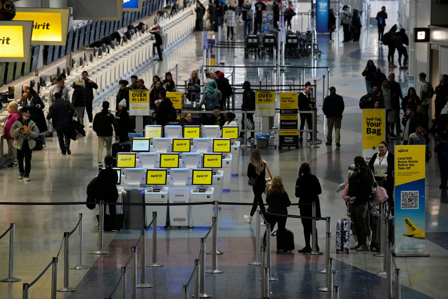 FILE - People check into their flights at Harry Reid International Airport, Jan. 11, 2023, in Las V...