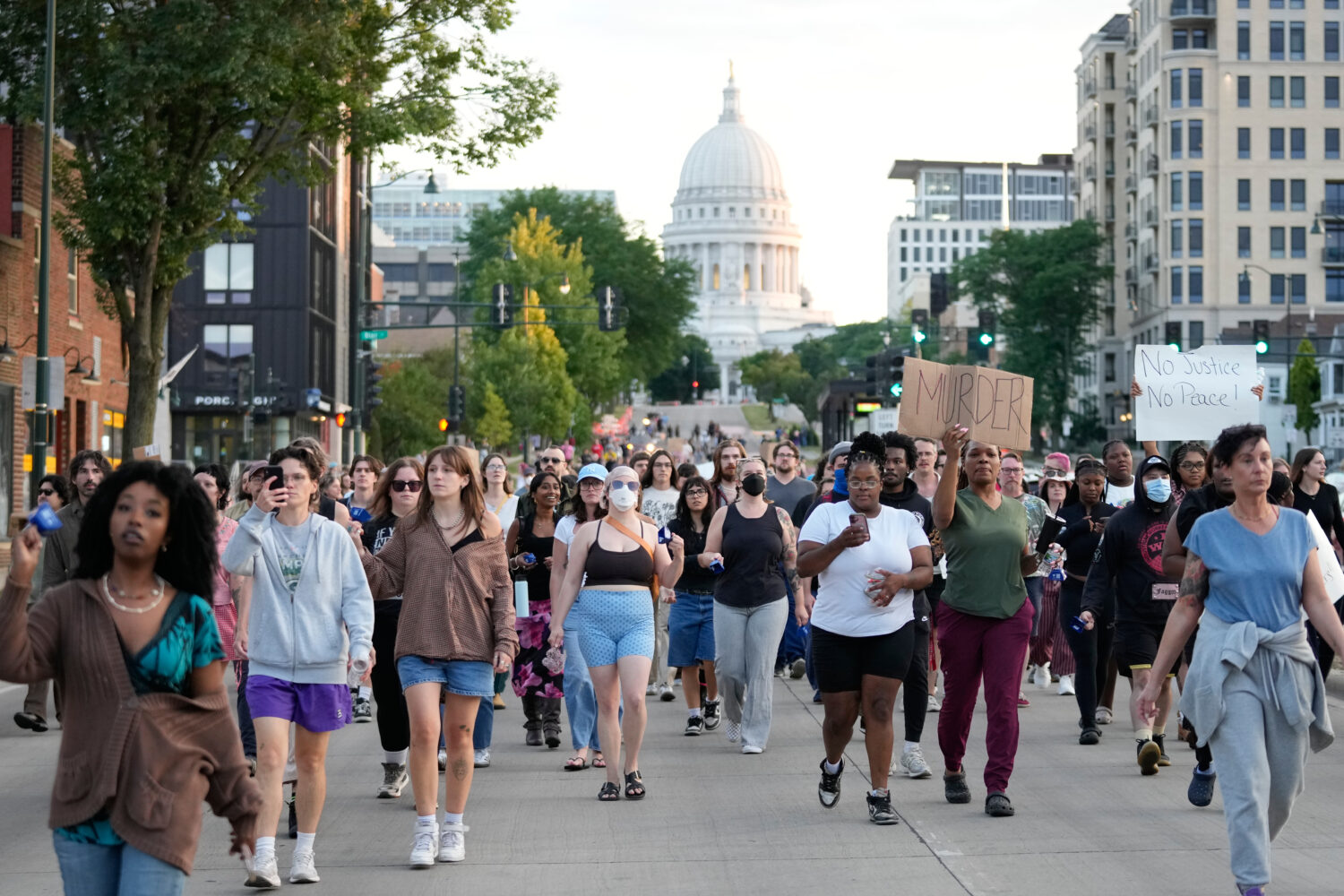 Protesters march after a Madison police officer shot and killed a man Wednesday, July 22, 2026, in ...