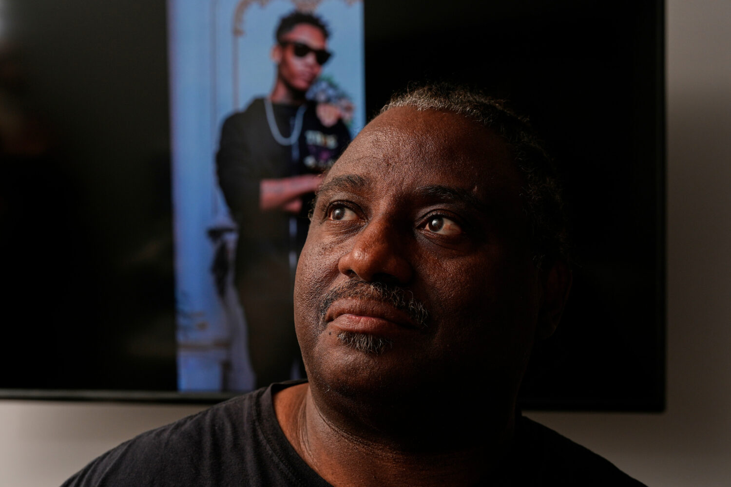 Evaniel Johnson poses with a picture of his grandson, Tyrin Johnson, Monday, July 6, 2026, in Nashv...