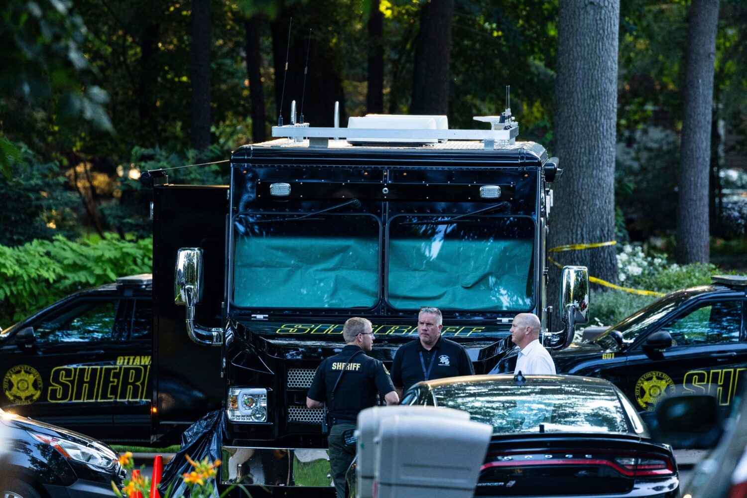 Law enforcement officials gather to investigate a fatal house fire on Friday, July 24, 2026, in Gra...