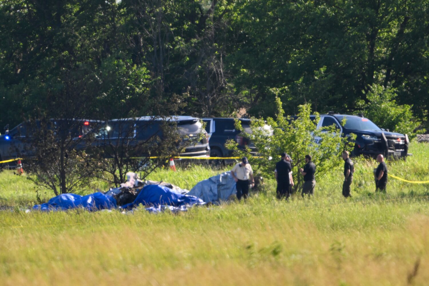 Emergency personnel investigate the site of a plane crash at the Butler Memorial Airport in Butler,...